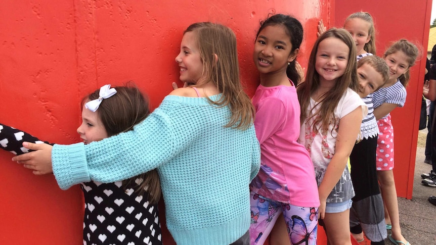 Kids embrace Geraldton lighthouse