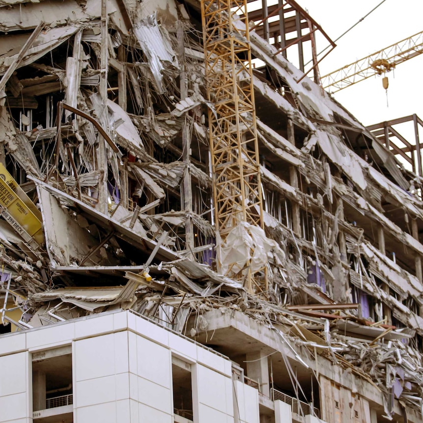 Debris hangs on the side of the building