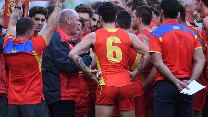 Rodney Eade speaking to Gold Coast Suns during a quarter-time huddle.