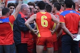 Rodney Eade speaking to Gold Coast Suns during a quarter-time huddle.