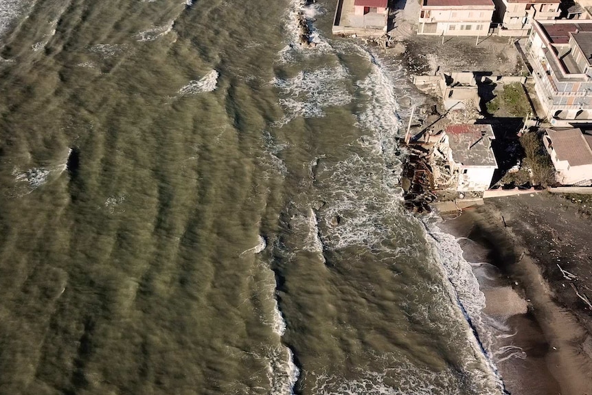 Waves was against a ruined home in Castel Volturno.