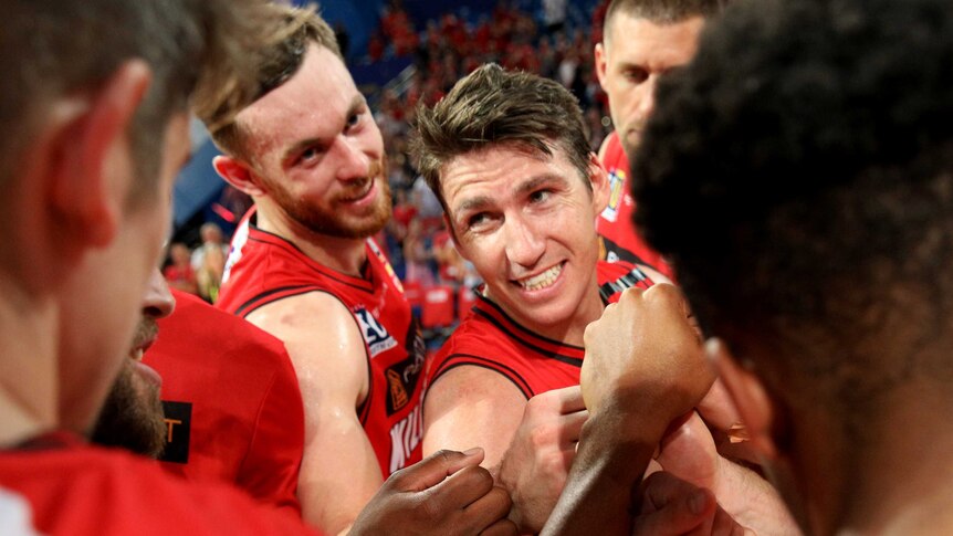 Perth Wildcats players in a team huddle.