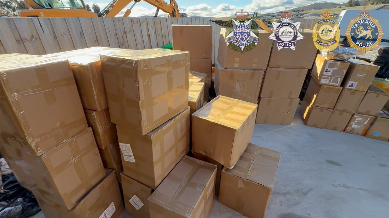 Dozens of boxes piled up in a yard