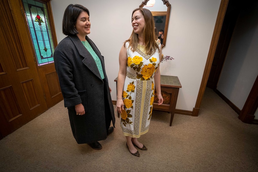 Alise Hardy and Eleanor Russell smile at each other as Eleanor tries on the dress