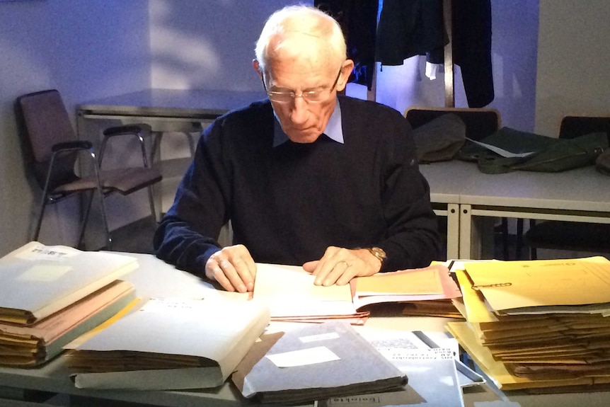 Man reads file kept on him by the German Stasi