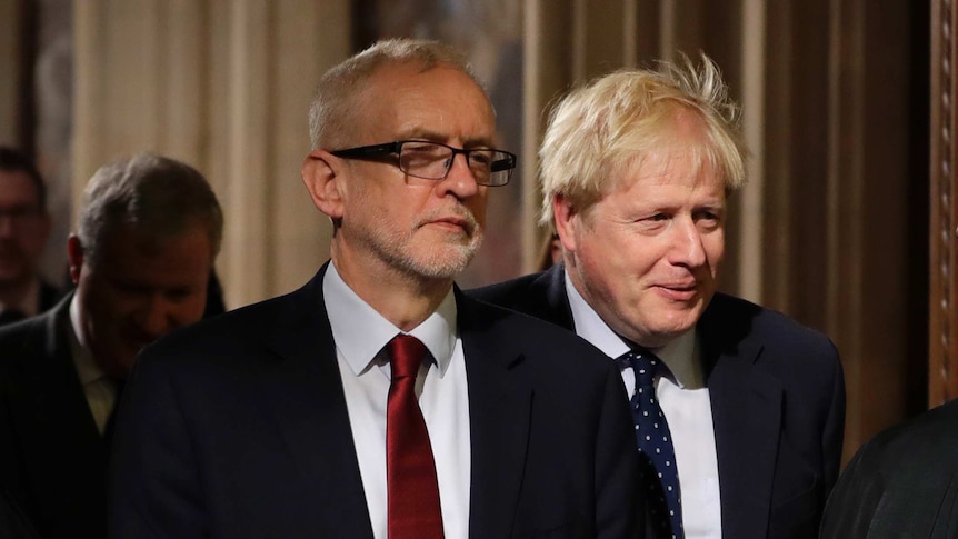 Boris Johnson stands behind opposition Labour Party Leader Jeremy Corbyn.