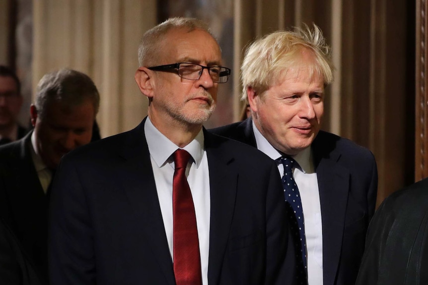 Boris Johnson stands behind opposition Labour Party Leader Jeremy Corbyn.