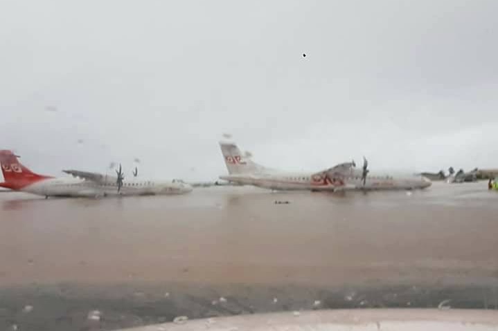Planes amid the flooding at Tahiti international airport.