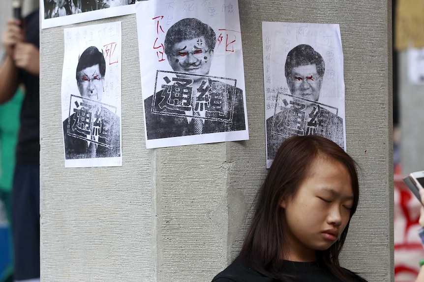 Education activist stands in front of protest poster in Taiwan