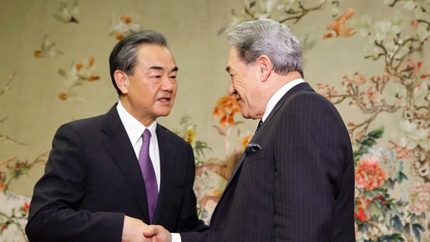 China's Foreign Minister Wang Yi, left, meets New Zealand's Foreign Minister Winston Peters.