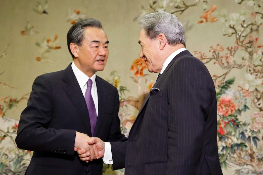 China's Foreign Minister Wang Yi, left, meets New Zealand's Foreign Minister Winston Peters.