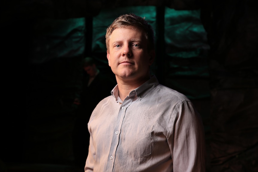 Andy Relf wears a blue business shirt and stares at the camera.