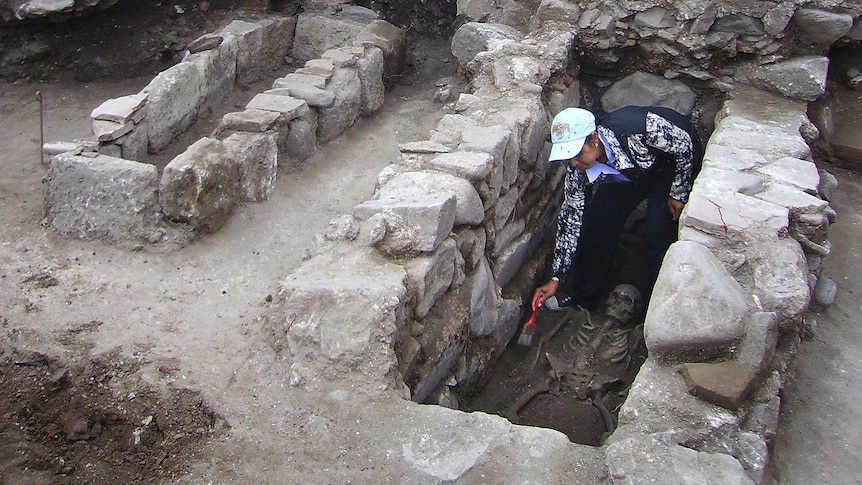 An archaeologist cleans a skeleton during archaeological excavations in the Black Sea town of Sozopol, Bulgaria.