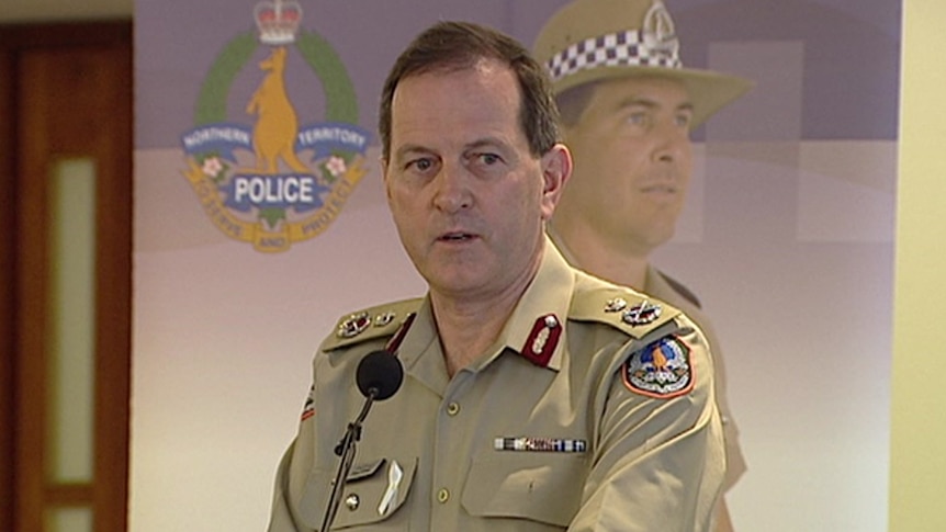 A man wearing a khaki police uniform and peaked cap