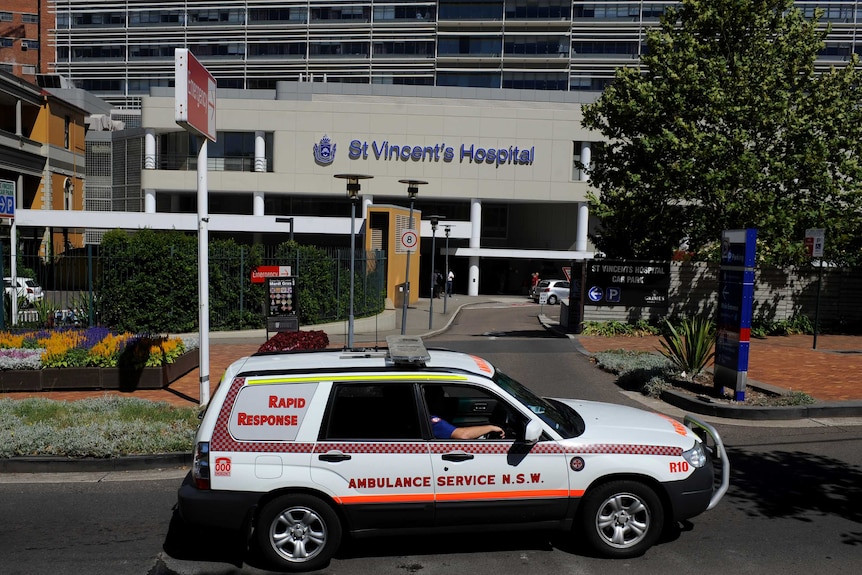 An ambulance passes the emergency entrance at a hospital.