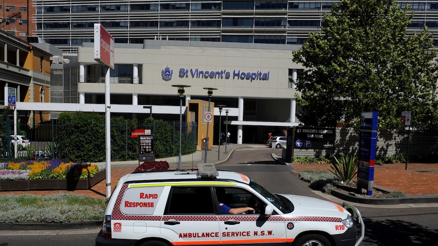 An ambulance passes the emergency entrance at a hospital.