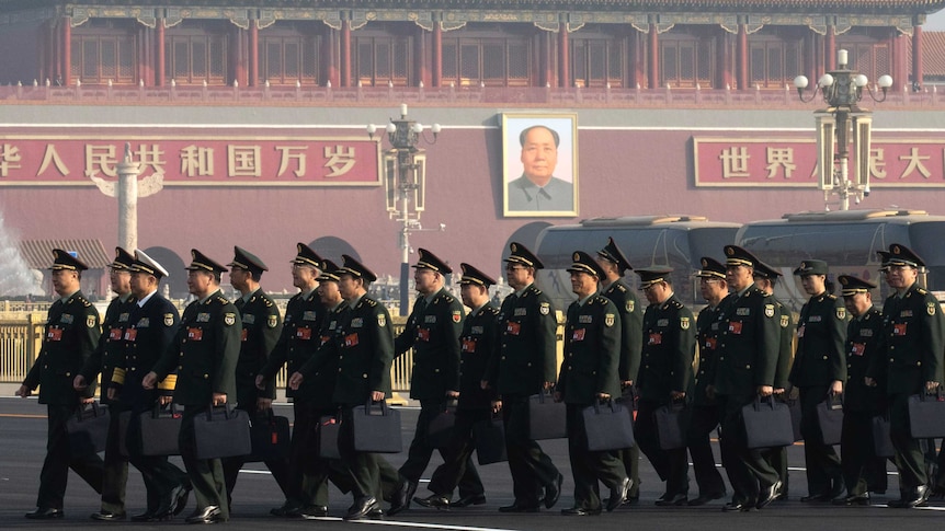 Chinese military delegates arrive, they are in Tiananmen Square, in front of the Forbidden City and Mao's portrait.