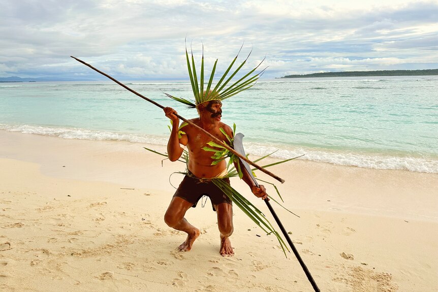 A man on Santa Catalina preparing to fight preparing to fight holding a spear 