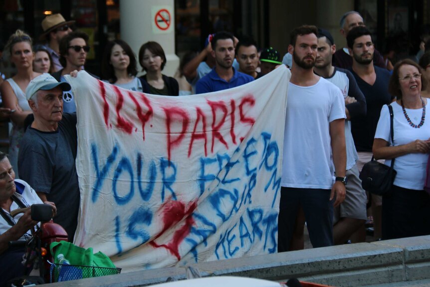 People holding pro-Paris banners were among the more than 500 people who gathered in Perth's Forrest Place.