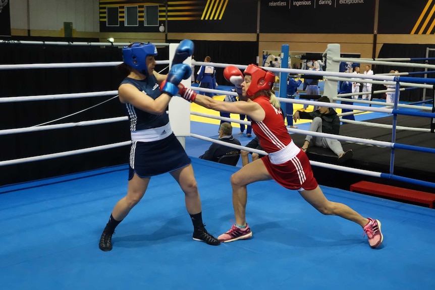 The gtwo boxers throw punches in the ring.