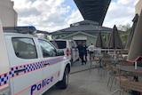 Police cars and officers outside a bar beneath Brisbane's Story Bridge