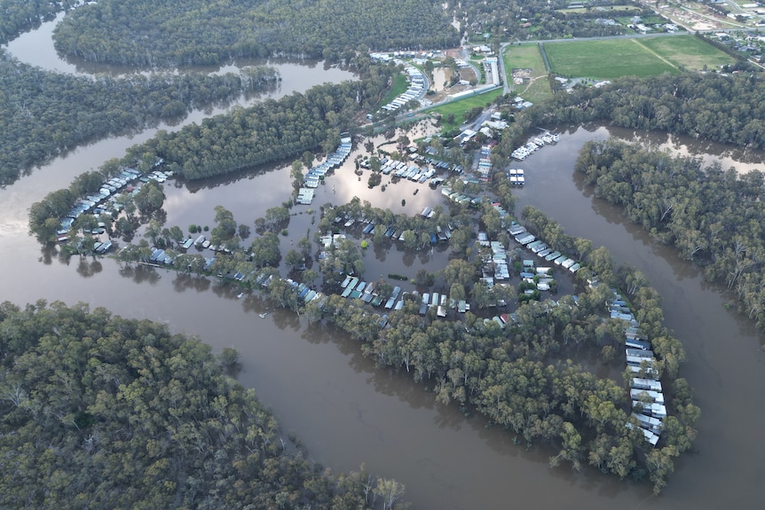 a birds eye view of a river and homes inundated