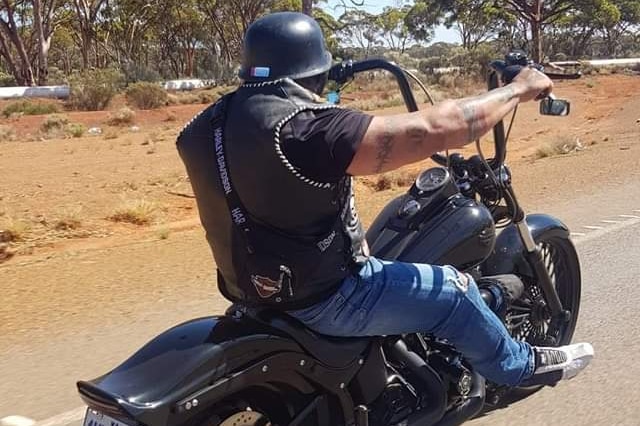 A man riding his motorbike