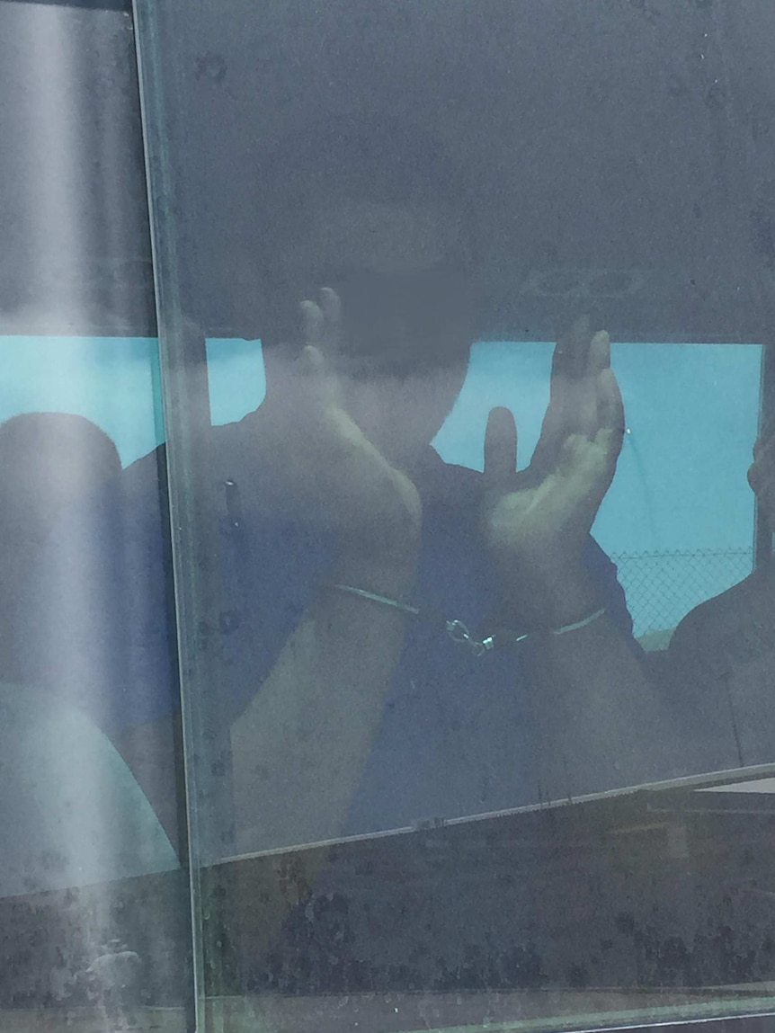 Christmas Island detainee in handcuffs after riot