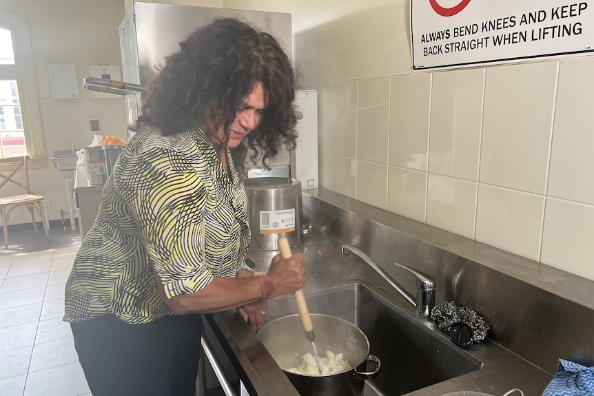 Njernda Aboriginal Corporation CEO Tracey Dillon stirs a pot of food.