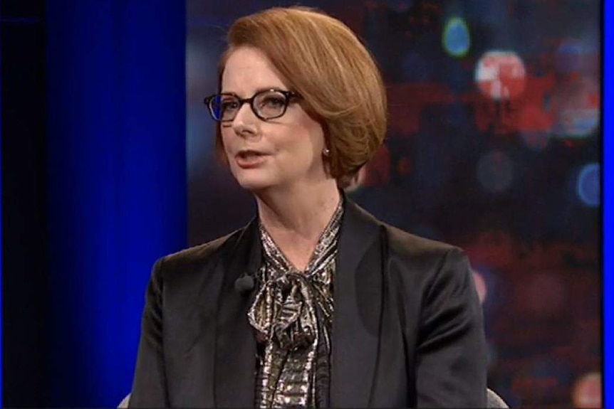 Former Australian prme minister Julia Gillard wears glasses and a dark jacket.