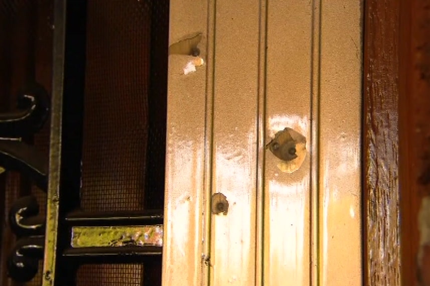 three large bullet holes in a house