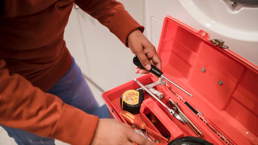 Toolbox next to a washing machine