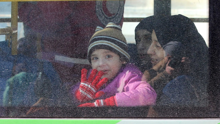 A child reacts from inside a bus evacuating people from a rebel-held sector of eastern Aleppo, Syria on December 15, 2016.