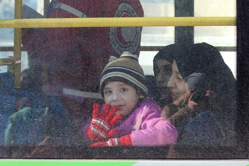 A child reacts from inside a bus evacuating people from a rebel-held sector of eastern Aleppo, Syria on December 15, 2016.