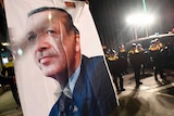 A large image of Turkish President Recep Tayyip Erdogan held up by protestors.