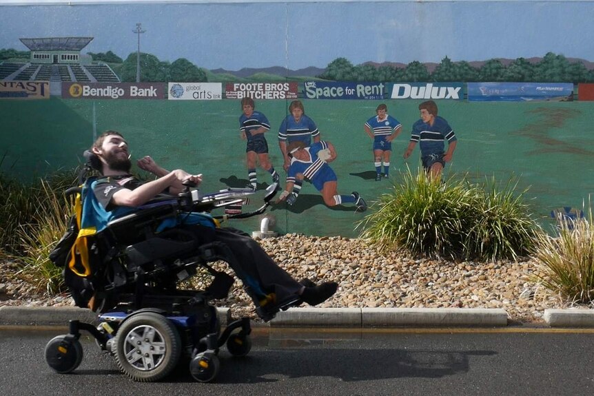 Tyson Turner-Thomas at the Ipswich Jets grounds in north Ipswich, a large mural is painted of the team playing.