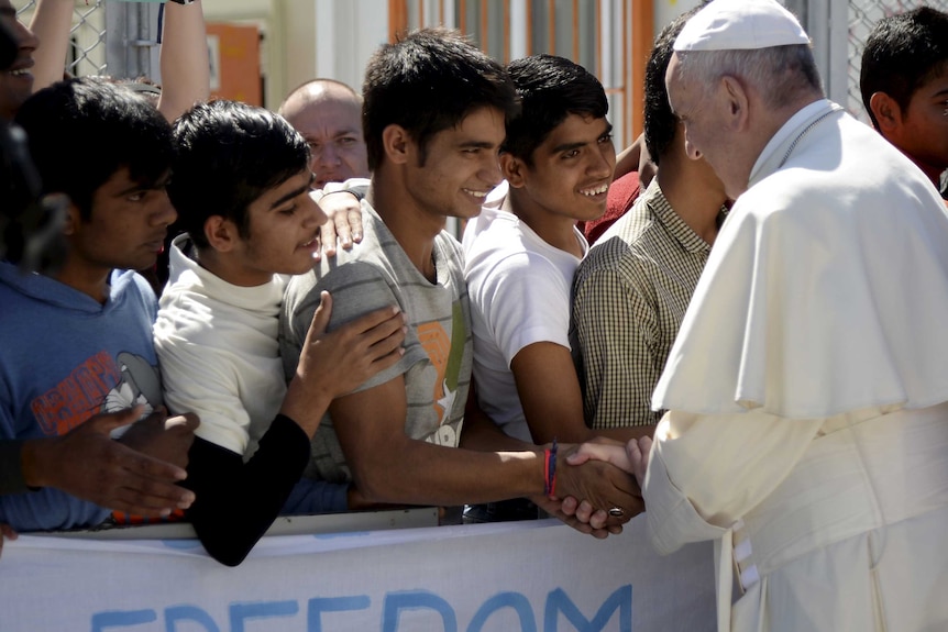 Pope Francis greets migrants and refugees