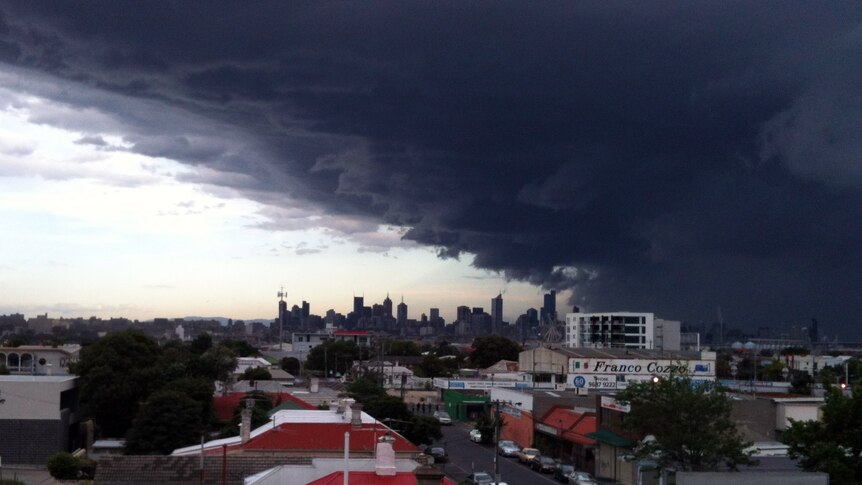 A large storm cloud pictured from Footscray looms over Melbourne