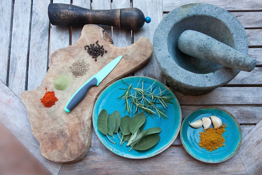 A pestle and mortar on a table with spices, for a story about alternatives to food processors.