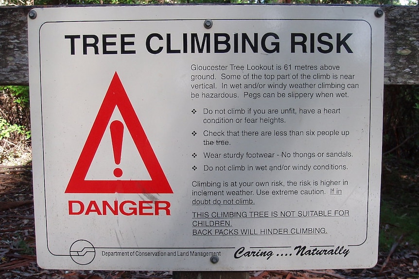 A sign warning of a tree climbing risk