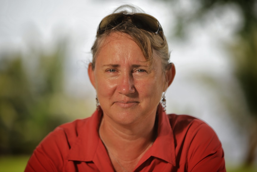 A woman with blonde hair wearing a red shirt.