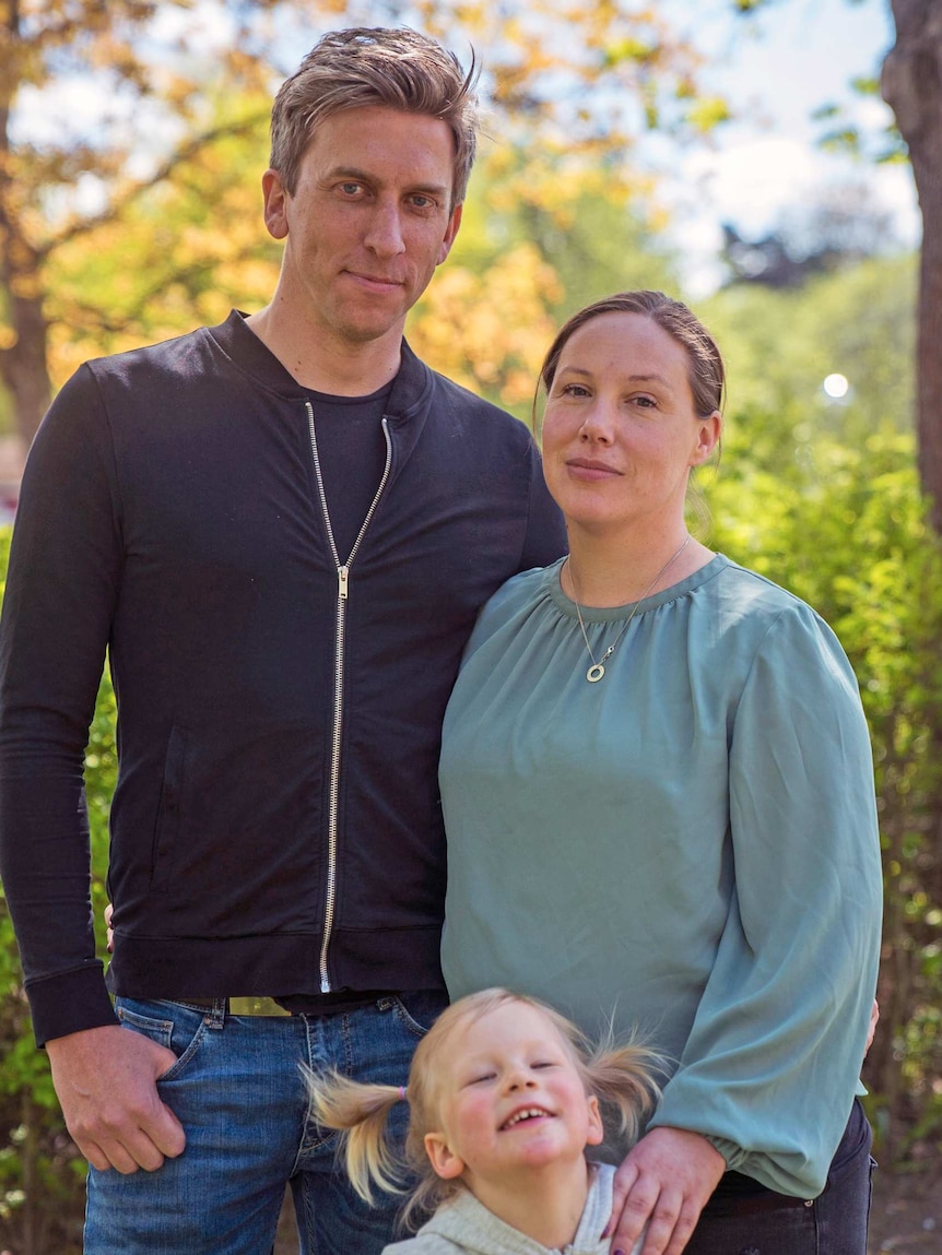 Mathias and Mina pose with their daughter.