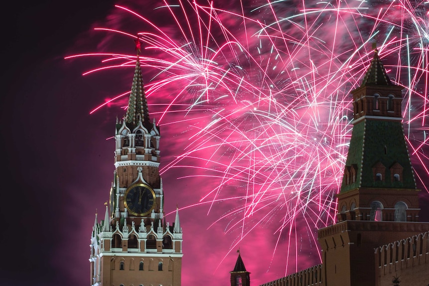 Pink fireworks explode over the Kremlin.