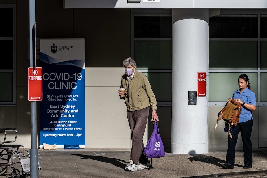 A man walking outside a COVID-19 clinic in Sydney.