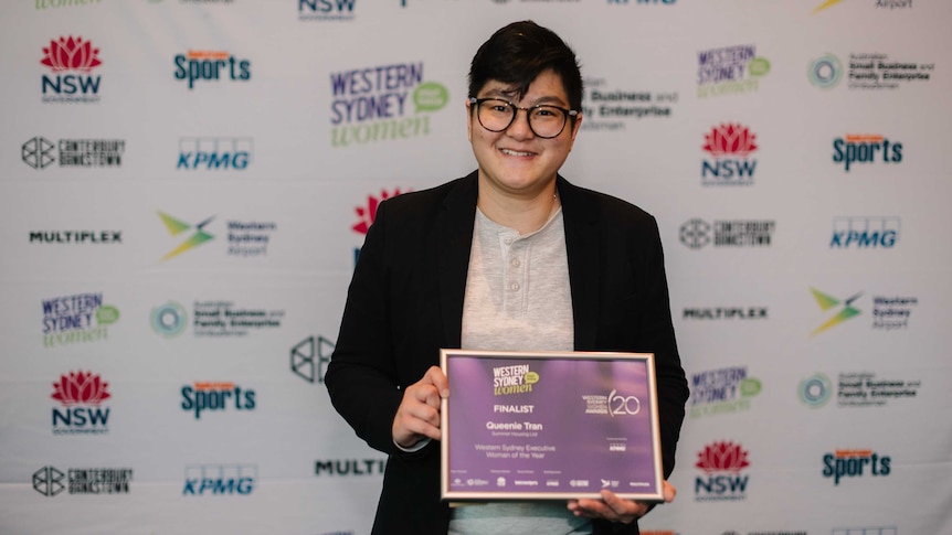 Queenie Tran holding a certificate at the Western Sydney Women Awards