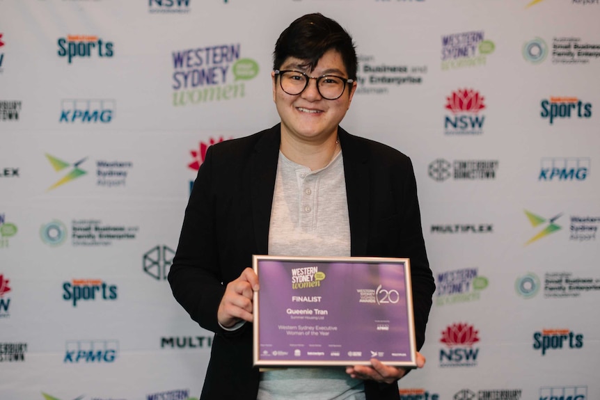 Queenie Tran holding a certificate at the Western Sydney Women Awards