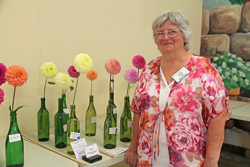 Kay Gray with a collection of dahlia entries.