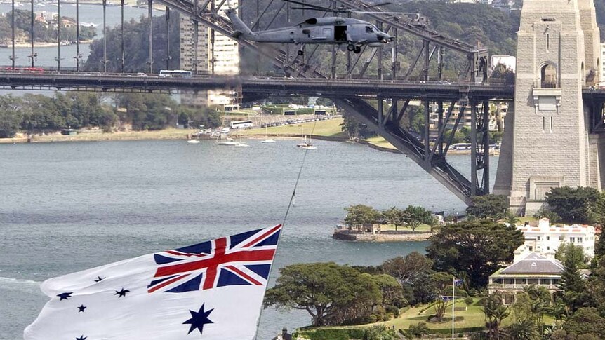 A Navy Seahawk helicopter flies above Sydney Harbour