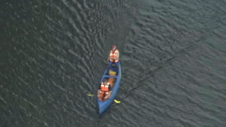Two rescuers in a canoe.