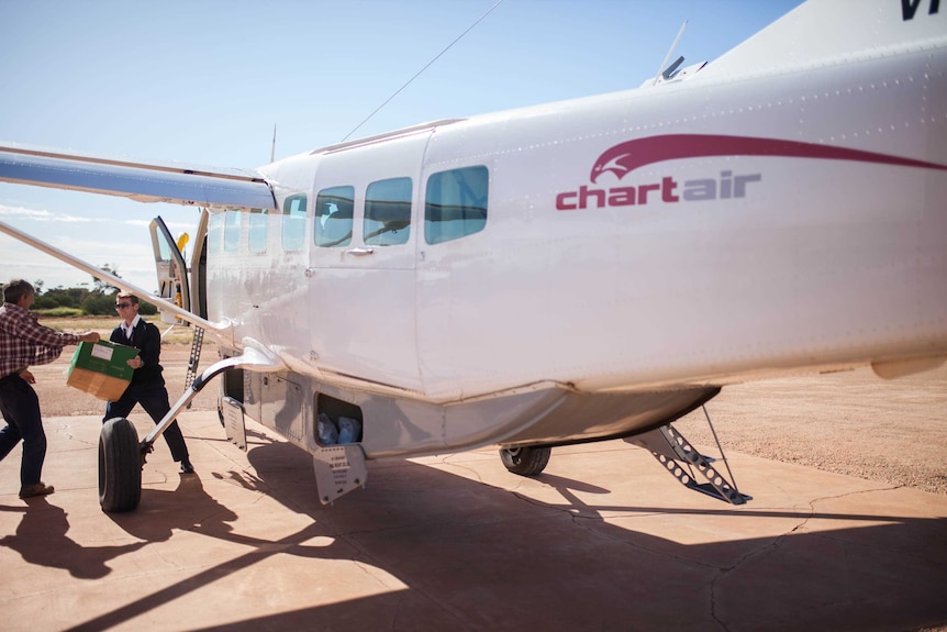 Chartair pilot Harvey Salameh unloads a plane in Tjuntjuntjara, remote WA.